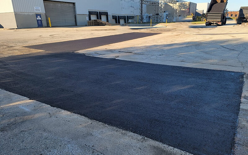 Freshly repaired asphalt parking lot